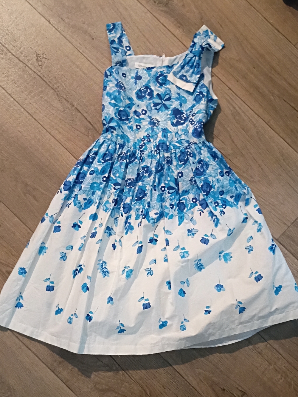 garment is a Bonnie Jean sleeveless blue and white floral fit-and-flare dress ta